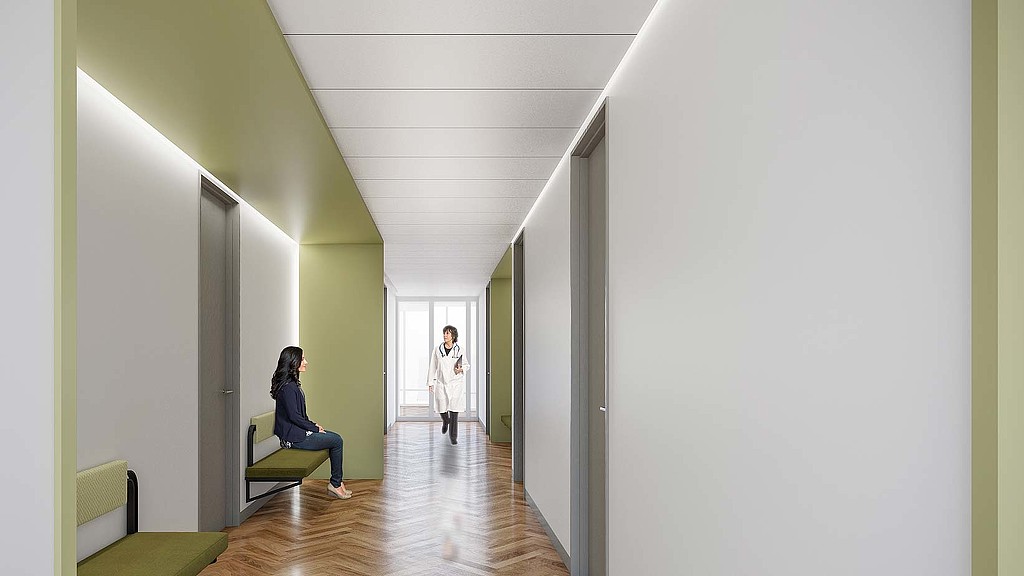 A person sitting on a chair in a hallway.